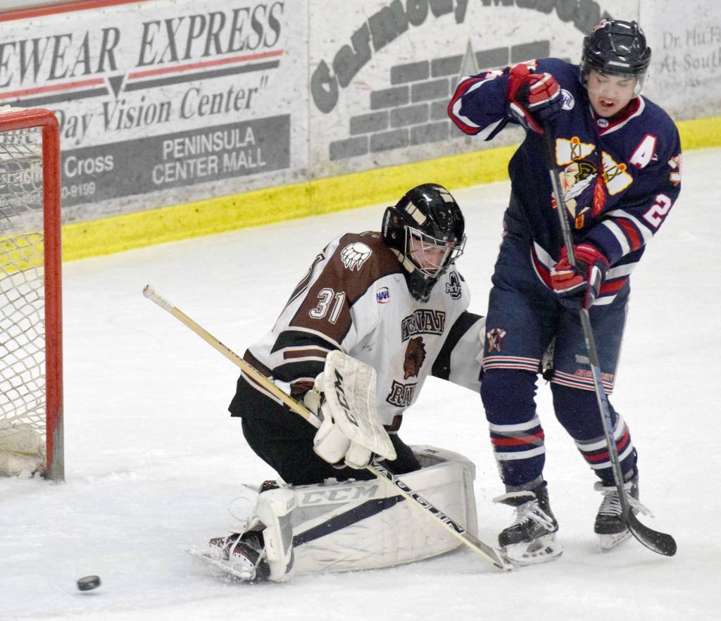 Kenai River Brown Bears goalie Kevin Lake steers an attempt by Samuel Solensky of the Johnstown (Pennsylvania) Tomahawks wide Friday, at the Soldotna Regional Sports Complex. (Photo by Jeff Helminiak/Peninsula Clarion)
