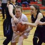 Kenai&rsquo;s Liz Hanson shoots between Palmer defenders Kassidy Bowman (right) and Sophia Benshelter, Friday night at Kenai Central High School. (Photo by Joey Klecka/Peninsula Clarion)