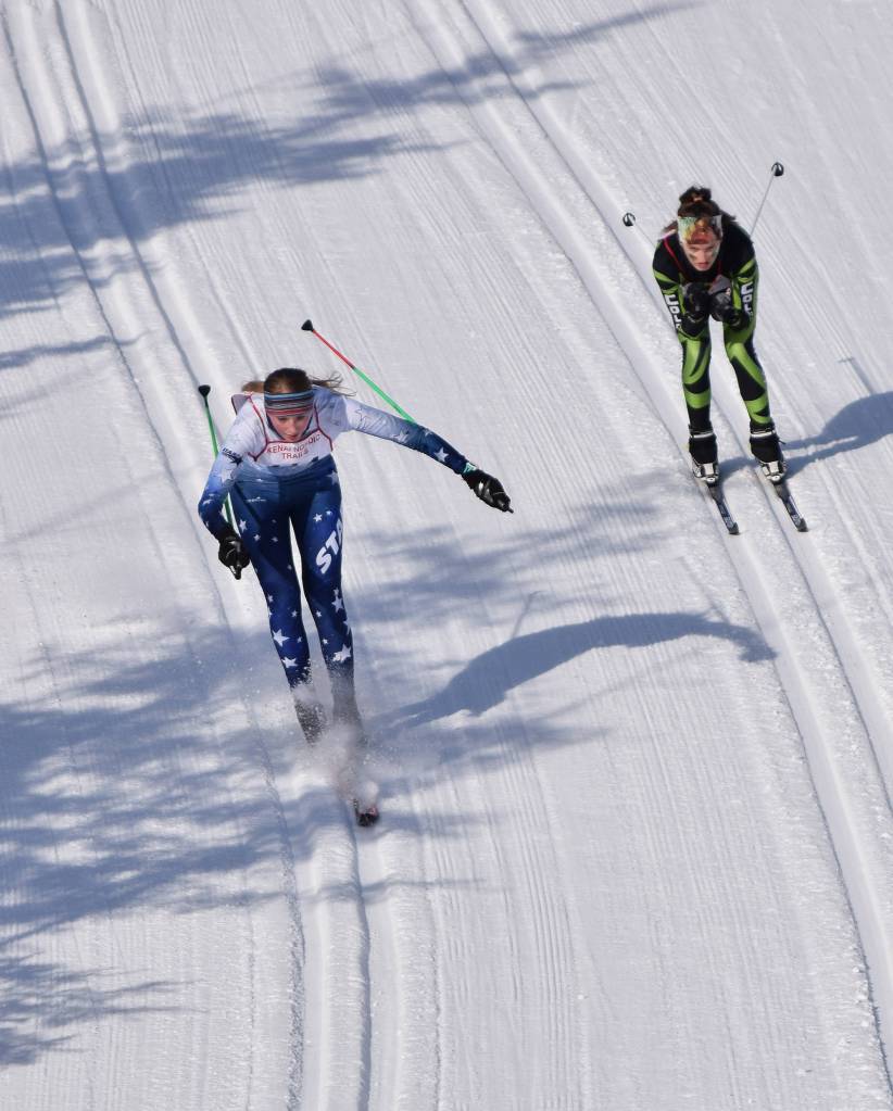 Cameron Blackwell of Soldotna (left) loses control on a late downhill Saturday afternoon in the girls race at the Region III skiing championships at the Tsalteshi Trails in Soldotna. (Photo by Joey Klecka/Peninsula Clarion)
