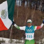 German Madrazo, of Mexico, holds up his flag after finishing last in the men&rsquo;s 15km freestyle cross-country skiing competition at the 2018 Winter Olympics in Pyeongchang, South Korea, Friday. (AP Photo/Kirsty Wigglesworth)