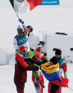 German Madrazo, of Mexico, holds up his countries flag after finishing last in the men&rsquo;s 15km freestyle cross-country skiing competition at the 2018 Winter Olympics in Pyeongchang, South Korea Feb. 16. (AP Photo/Dmitri Lovetsky)