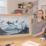 Tasha with an example of a custom framed piece at Frames & Things.