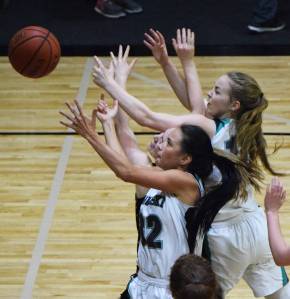 Rylee Jackson of Nikiski contends for a rebound Thursday night against Grace Christian at Nikiski High School. (Photo by Joey Klecka/Peninsula Clarion)