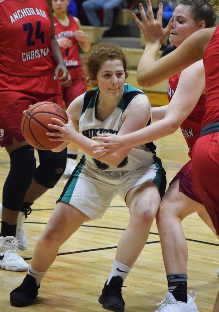 Nikiski&rsquo;s Angela Druesedow cuts through a swarm of ACS defenders Friday at Nikiski High School. (Photo by Joey Klecka/Peninsula Clarion)
