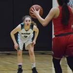 Nikiski sophomore America Jeffreys keeps her eye on ACS guard Destiny Reimers Friday at Nikiski High School. (Photo by Joey Klecka/Peninsula Clarion)