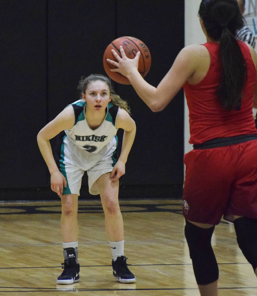 Nikiski sophomore America Jeffreys keeps her eye on ACS guard Destiny Reimers Friday at Nikiski High School. (Photo by Joey Klecka/Peninsula Clarion)