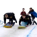 Patrol Officer Josh Hall, left, and School Resource Officer Dan Smith take a turn sledding down the Olympic course set up for the Boys and Girls Club&rsquo;s Police Athletic League (P.A.L.) Club in Kenai on Monday. The club is a sports-oriented opportunity for youth and law enforcement to interact and organizers set-up an Olympics inspired day where the kids competed for medals in different winter activities. (Photo by Kat Sorensen/Peninsula Clarion)