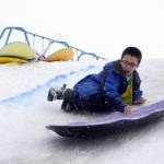 Kaizen Fuller flies through his sled run at the Boys and Girls Club in Kenai for the Police Athletic League Club on Monday. The club is a sports-oriented opportunity for youth and law enforcement to interact and organizers set-up an Olympics inspired day where the kids competed for medals in different winter activities. (Photo by Kat Sorensen/Peninsula Clarion)