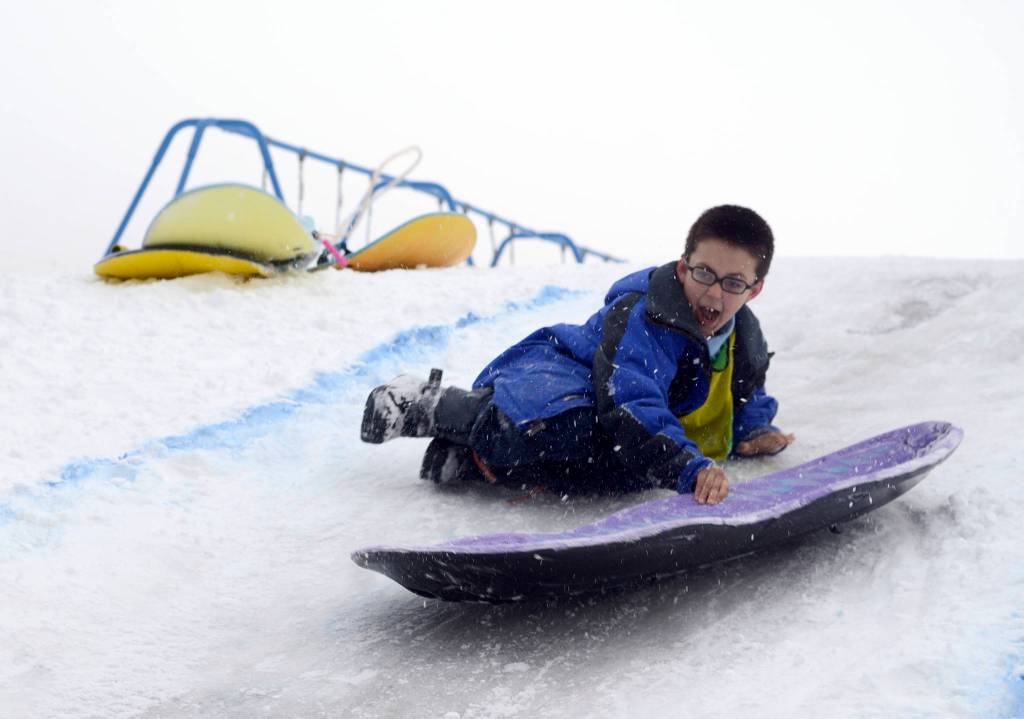 Kaizen Fuller flies through his sled run at the Boys and Girls Club in Kenai for the Police Athletic League Club on Monday. The club is a sports-oriented opportunity for youth and law enforcement to interact and organizers set-up an Olympics inspired day where the kids competed for medals in different winter activities. (Photo by Kat Sorensen/Peninsula Clarion)