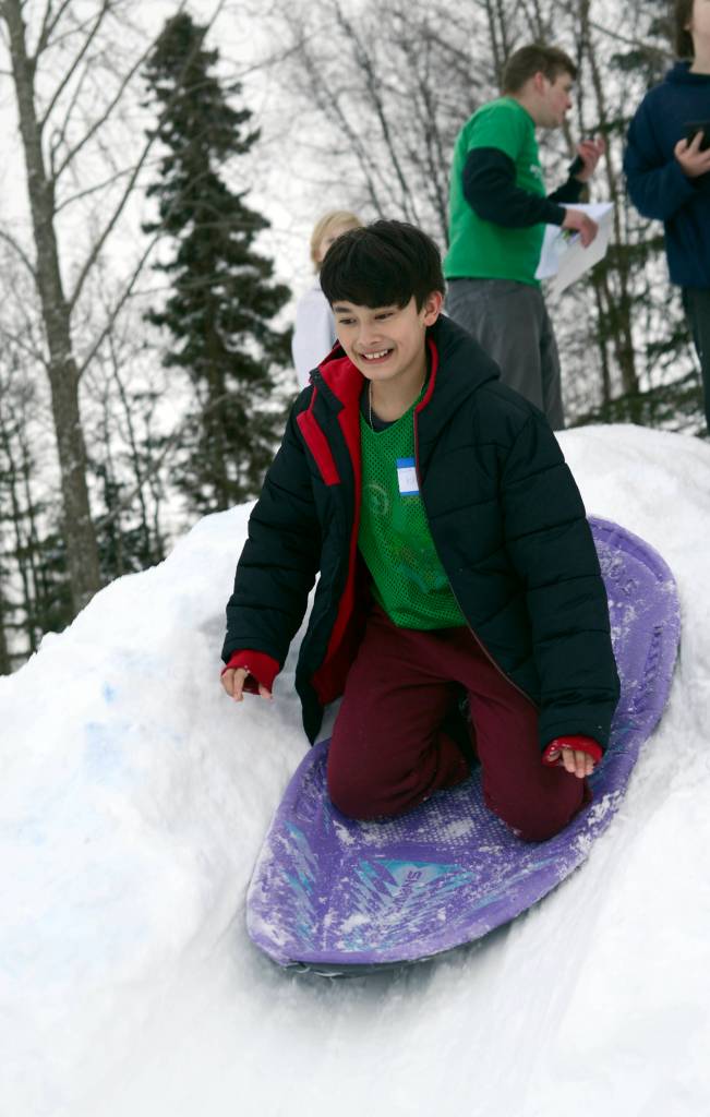 Daniel Burtrain takes off for his sledding run at the Boys and Girls Club in Kenai for the Police Athletic League Club on Monday. The P.A.L. club is a sports-oriented opportunity for youth and law enforcement to interact and organizers set-up an Olympics inspired day where the kids competed for medals in different winter activities. (Photo by Kat Sorensen/Peninsula Clarion)