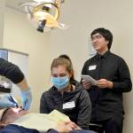 Kenai Central High School juniors Hannah Olson, right, and Natalia O&rsquo;Toole shadow Kylie Zeyer, a dental hygenist with Denali Family Dentistry on job shadow day Wednesday in Kenai. Delbrian Parfitt, center, reports for the Clarion on the job shadow event. (Photo by Maria Salzetti/For the Clarion)