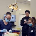 Kenai Central High School junior Natalia O&rsquo;Toole shadows Kylie Zeyer, a dental hygenist with Denali Family Dentistry on job shadow day Wednesday in Kenai. Delbrian Parfitt, center, reports for the Clarion on the job shadow event. (Photo by Maria Salzetti/For the Clarion)