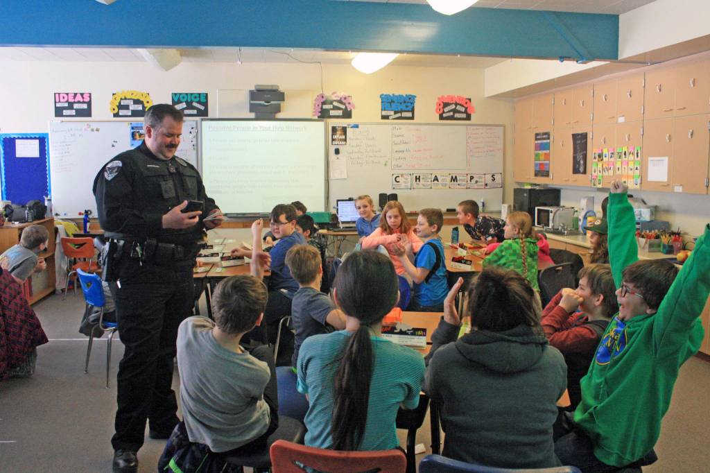 Soldotna Police Officer Tobin Brennan quizzes fifth-graders on D.A.R.E. glossary terms during a lesson at Soldotna Elementary School on Feb. 28. (Photo by Erin Thompson/Peninsula Clarion)