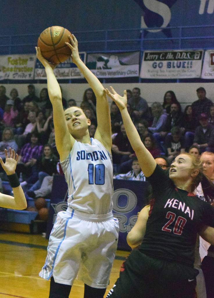 Soldotna&rsquo;s Aliann Schmidt grabs a rebound over Kenai Central&rsquo;s LIz Hanson (20) Saturday night at Soldotna High School. (Photo by Joey Klecka/Peninsula Clarion)