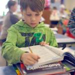 Lincoln Kimbell works out of a textbook during Nikiski North Star&rsquo;s &lsquo;screen-free&rsquo; week Friday in Nikiski. Students and staff unplugged their technology for the entire week, giving the students a chance to compare their educational experience with and without technology. (Photo by Kat Sorensen/Peninsula Clarion)