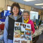 Nancy Myers, left, and her mother Betty Harris share family photos memorializing family patriarch Jim Harris, who died of cancer in 2017 on Saturday, Feb. 24, 2018 near Ninilchik, Alaska. Jim Harris was honored at this year&rsquo;s WOW event. (Photo by Erin Thompson/Peninsula Clarion)