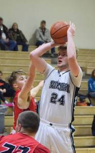 Nikiski&rsquo;s Cody Handley takes a shot March 2, 2018, against Houston at Nikiski High School. (Photo by Joey Klecka/Peninsula Clarion)