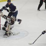Kenai River goaltender Gavin Enright stretches for a save with Janesville (Wisconsin) skater Jack Vincent bearing down on him Friday night at the Soldotna Regional Sports Complex. (Photo by Joey Klecka/Peninsula Clarion)