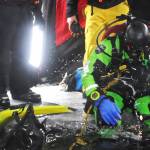Kassidy Stock of the Nikiski Fire Department prepares to dive through a hole in the ice on Island Lake as part of a diving training drill Friday, March 9, 2018 in Nikiski, Alaska. The Nikiski Fire Department is working on getting its ice diving team up to certifications to perform operations on frozen lakes if need be, such as rescuing sunken cars or people or recovering evidence. (Photo by Elizabeth Earl/Peninsula Clarion)