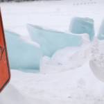 Three-foot high blocks of ice sit on the frozen surface of Island Lake near a sign warning the public that the Nikiski Fire Department is conducting an ice diving drill on Friday, March 9, 2018 in Nikiski, Alaska. The Nikiski Fire Department is working on bringing all the members of its ice diving team up to proper certifications. To attain full certifications, divers have to clock a number of hours in the water, including practicing beneath the ice. (Photo by Elizabeth Earl/Peninsula Clarion)