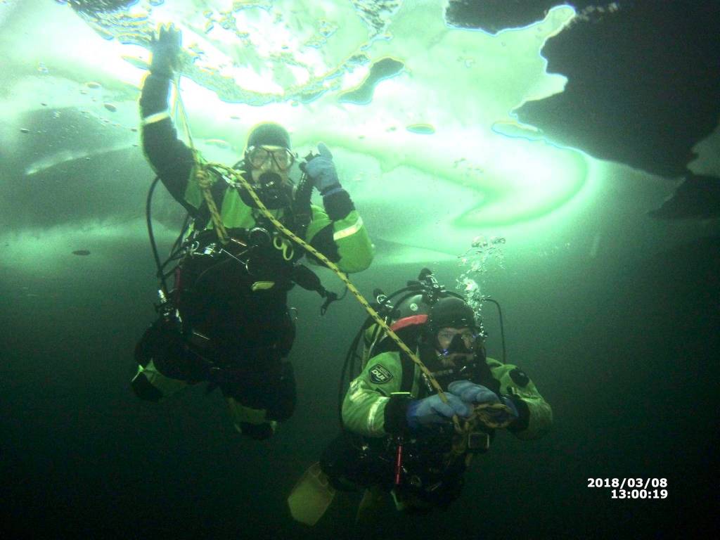 Nikiski Fire Department Senior Captain Bryan Crisp and firefighter Stephen Robertson dive beneath the ice of Island Lake on Thursday, March 8, 2018 in Nikiski, Alaska. Crisp and Robertson are leading an effort to rebuild Nikiski Fire Department&rsquo;s ice diving team. (Photo courtesy Bryan Crisp)