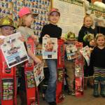 ABOVE: Little kids catch big fish & prizes in Trustworthy Ice Fishing Derby. LEFT: Ice fishermen and Trustworthy staff gather in the store for the finish of the annual Ice Fishing Derby and the award ceremony.