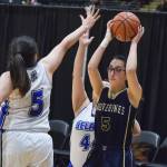Ninilchik&rsquo;s Olivia Delgado (right) finds herself surrounded by Selawik defenders Laura Ramoth (5) and Marita Ticket, Wednesday in an opening round contest at the Class 1A state basketball tournament at the Alaska Airlines Center in Anchorage. (Photo by Joey Klecka/Peninsula Clarion)