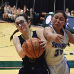 Ninilchik&rsquo;s Olivia Delgado keeps the ball away from Selawik&rsquo;s Kali Howarth Wednesday in an opening round contest at the Class 1A state basketball tournament at the Alaska Airlines Center in Anchorage. (Photo by Joey Klecka/Peninsula Clarion)