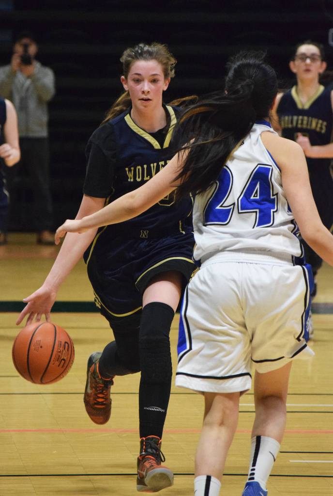 Ninilchik&rsquo;s DeeAnn White dribbles the ball down the court Wednesday in an opening round contest against Selawik&rsquo;s Davis Ramoth school at the Class 1A state basketball tournament at the Alaska Airlines Center in Anchorage. (Photo by Joey Klecka/Peninsula Clarion)