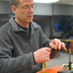 Dave Atcheson ties a fly for fly fishing at Kenai Peninsula College&rsquo;s student service Thursday March 8 in Soldotna. Atcheson teaches a beginning fly fishing course at the college that is open to the public. Deadline for registration is March 19. (Photo by Kat Sorensen/Peninsula Clarion)