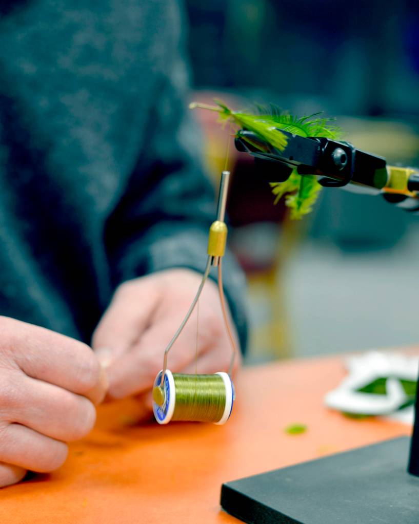RIGHT: Dave Atcheson ties a wooly bugger for fly fishing at Kenai Peninsula College&rsquo;s student service Thursday March 8 in Soldotna. Atcheson teaches a beginning fly fishing course at the college that is open to the public. Deadline for registration is March 19. (Photo by Kat Sorensen/Peninsula Clarion)