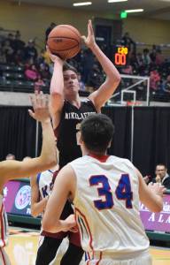 Nikolaevsk&rsquo;s Kalenik Molodih eyes the rim Wednesday against the Kake Thunderbirds at the Class 1A boys state tournament at the Alaska Airlines Center in Anchorage. (Photo by Joey Klecka/Peninsula Clarion)