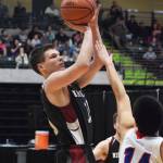 Nikolaevsk&rsquo;s Sage Stanish shoots a jumper over the Kake defense Wednesday at the Class 1A boys state tournament at the Alaska Airlines Center in Anchorage. (Photo by Joey Klecka/Peninsula Clarion)