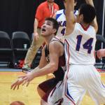 Nikolaevsk&rsquo;s Michael Trail moves his way under the rim against Kake&rsquo;s Simon Friday (14) Wednesday at the Class 1A boys state tournament at the Alaska Airlines Center in Anchorage. (Photo by Joey Klecka/Peninsula Clarion)