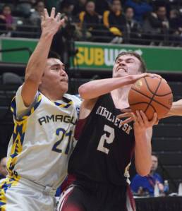 Nikolaevsk&rsquo;s Kalenik Molodih drives to the rim against Nunamiut&rsquo;s Dyrell Lincoln Thursday in a Class 1A state tournament quarterfinal at the Alaska Airlines Center in Anchorage. (Photo by Joey Klecka/Peninsula Clarion)