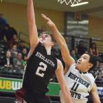 Nikolaevsk&rsquo;s Kalenik Molodih (2) lays in a bucket against Shishmaref&rsquo;s Fred Sinnok Friday in a Class 1A state tournament fourth-place semifinal contest at the Alaska Airlines Center. (Photo by Joey Klecka/Peninsula Clarion)
