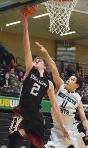Nikolaevsk&rsquo;s Kalenik Molodih (2) lays in a bucket against Shishmaref&rsquo;s Fred Sinnok Friday in a Class 1A state tournament fourth-place semifinal contest at the Alaska Airlines Center. (Photo by Joey Klecka/Peninsula Clarion)