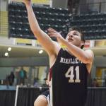 Nikolaevsk junior Michael Trail puts up a layup Friday in a Class 1A state tournament fourth-place semifinal contest against Shishmaref at the Alaska Airlines Center. (Photo by Joey Klecka/Peninsula Clarion)