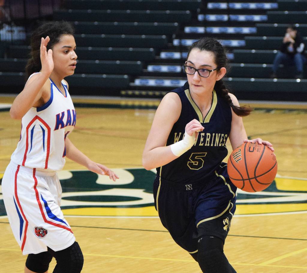 Ninilchik senior Olivia Delgado dribbles by Kake&rsquo;s Willow Jackson (left) Saturday in the Class 1A girls state tournament fourth-place game at the Alaska Airlines Center in Anchorage. (Photo by Joey Klecka/Peninsula Clarion)
