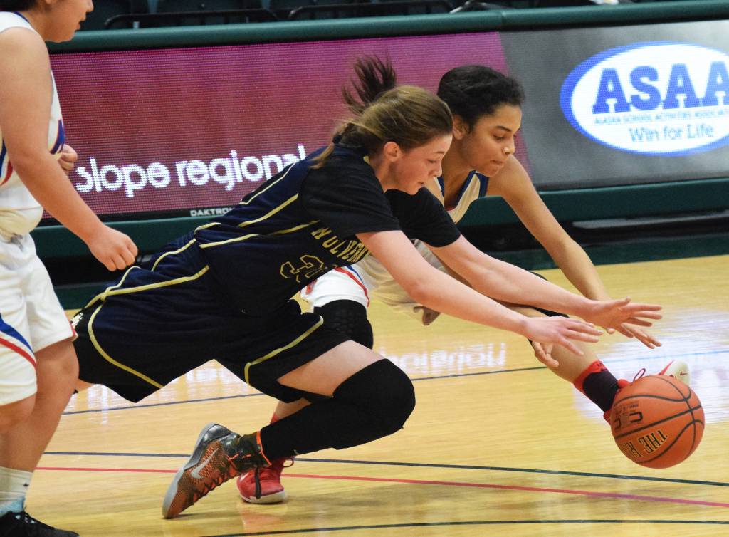Ninilchik&rsquo;s DeeAnn White dives for a loose ball with Kake&rsquo;s Willow Jackson Saturday in the Class 1A girls state tournament fourth-place game at the Alaska Airlines Center in Anchorage. (Photo by Joey Klecka/Peninsula Clarion)