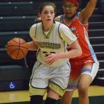 Ninilchik&rsquo;s DeeAnn White fends off a Toksook Bay defender Friday in a Class 1A state tournament consolation game at the Alaska Airlines Center in Anchorage. (Photo by Joey Klecka/Peninsula Clarion)