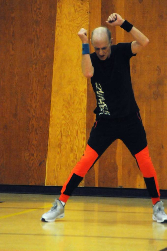 Zumba instructor Truman Krogel leads a class at the Kenai Recreation Center on Thursday, March 15, 2018 in Kenai, Alaska. Krogel, 74, said he first tried Zumba himself four years ago, loved it and began teaching classes of his own in January 2017. (Photo by Elizabeth Earl/Peninsula Clarion)