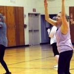 Sallie Macy (right) and Bobbie Baldwin (left) dance during Truman Krogel&rsquo;s Zumba Gold class at the Kenai Recreation Center on Thursday, March 15, 2018 in Kenai, Alaska. Krogel, 74, said he first tried Zumba himself four years ago, loved it and began teaching classes of his own in January 2017. (Photo by Elizabeth Earl/Peninsula Clarion)