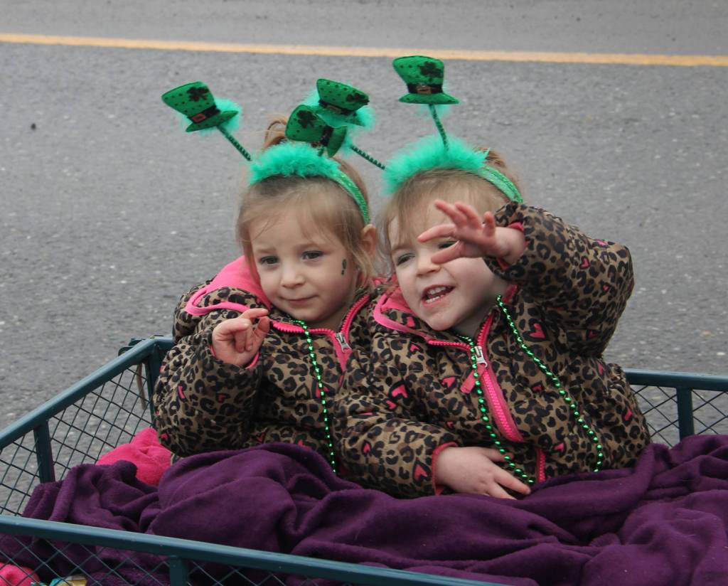 Twin lassies wave along the way of Soldotna&rsquo;s St. Patrick&rsquo;s Day parade.