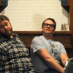 Chris Pepper (right) and Shaylon Cochran (left) stare into the distance during a rehearsal for Triumvirate Theatre&rsquo;s production of &ldquo;Forrest Guppy&rdquo; on Tuesday, March 20, 2018 in Soldotna, Alaska. Pepper plays Forrest Guppy, a parody of the main character from the classic film &ldquo;Forrest Gump,&rdquo; in the comedy parody of the film. The theater troupe last put on the dinner theater production in 2010. (Photo by Elizabeth Earl/Peninsula Clarion)