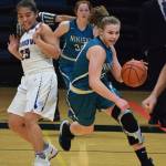 Nikiski&rsquo;s Bethany Carstens (right) dodges Barrow defender Jordan Ahgeak in the second half of a quarterfinal contest Thursday evening at the Class 3A state tournament at the Alaska Airlines Center. (Photo by Joey Klecka/Peninsula Clarion)
