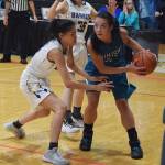 Nikiski&rsquo;s Rylee Jackson (right) looks for space against Barrow&rsquo;s Lewanne Brower, Thursday evening at the Class 3A state tournament at the Alaska Airlines Center. (Photo by Joey Klecka/Peninsula Clarion)