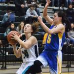 Nikiski&rsquo;s Kelsey Clark shoots against Bethel&rsquo;s Dorothy Bukowski (right) Saturday in the Class 3A girls state tournament fourth-place game at the UAA Wells Fargo Complex in Anchorage. (Photo by Joey Klecka/Peninsula Clarion)