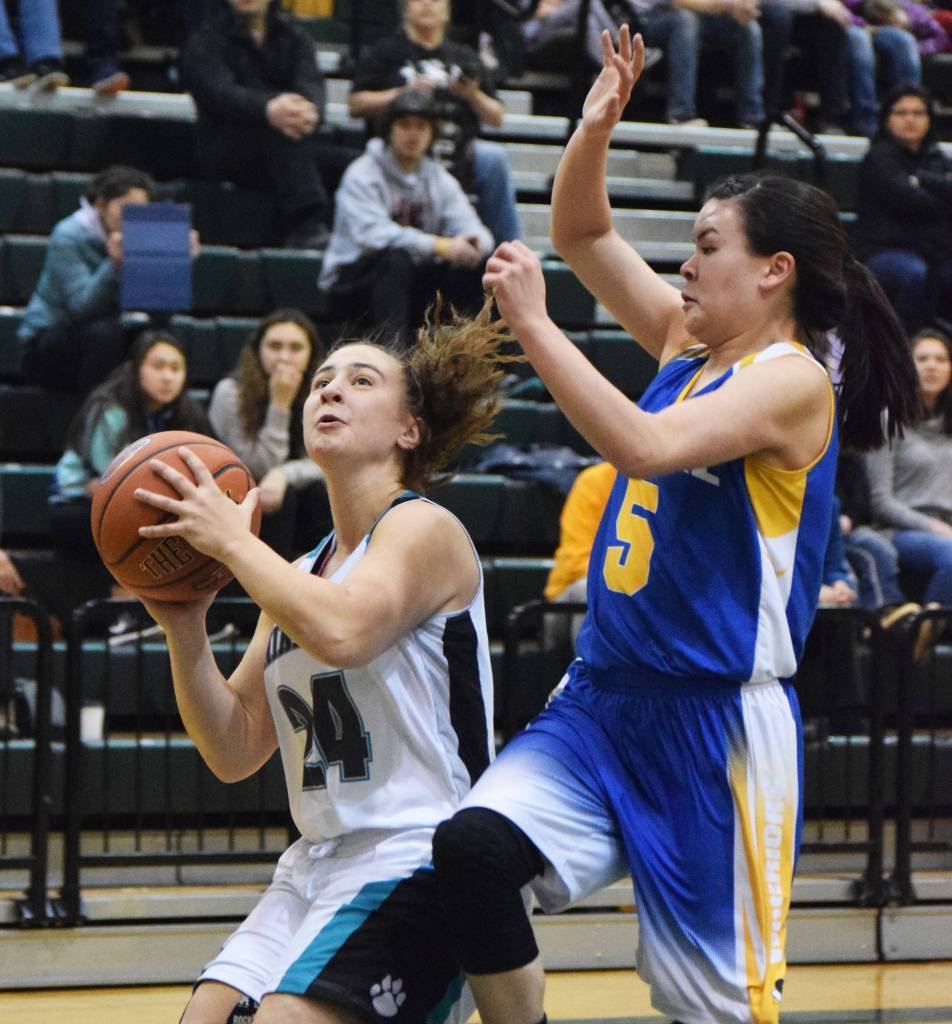 Nikiski&rsquo;s Kelsey Clark shoots against Bethel&rsquo;s Dorothy Bukowski (right) Saturday in the Class 3A girls state tournament fourth-place game at the UAA Wells Fargo Complex in Anchorage. (Photo by Joey Klecka/Peninsula Clarion)