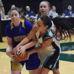 Kotzebue&rsquo;s Payton McConnell (left) battles for a rebound with Nikiski&rsquo;s Rylee Jackson, Friday at the Class 3A state tournament at the Alaska Airlines Center. (Photo by Joey Klecka/Peninsula Clarion)